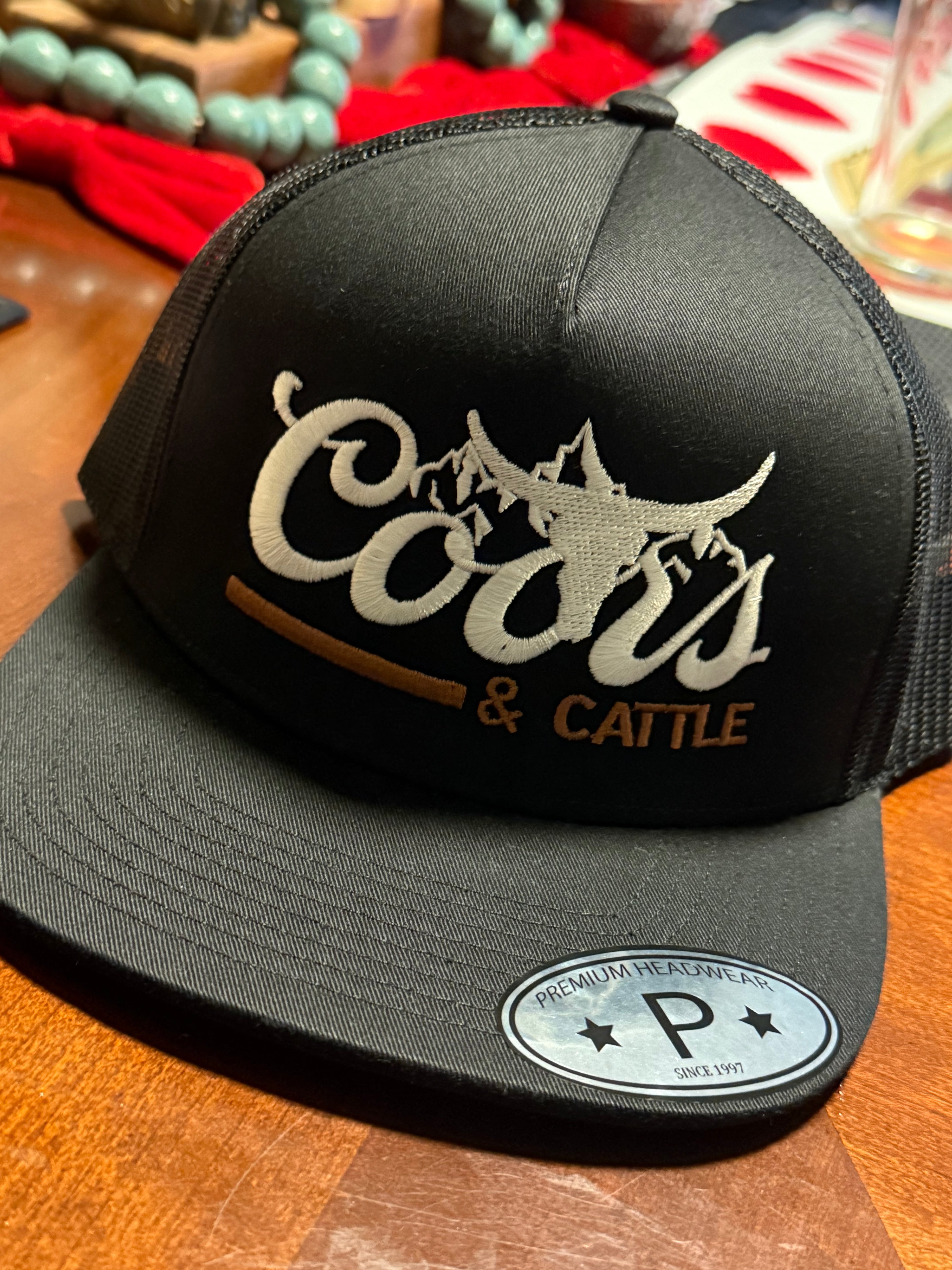 Coors and Cattle Embroidered
Flat Bill Trucker Hat “Black”