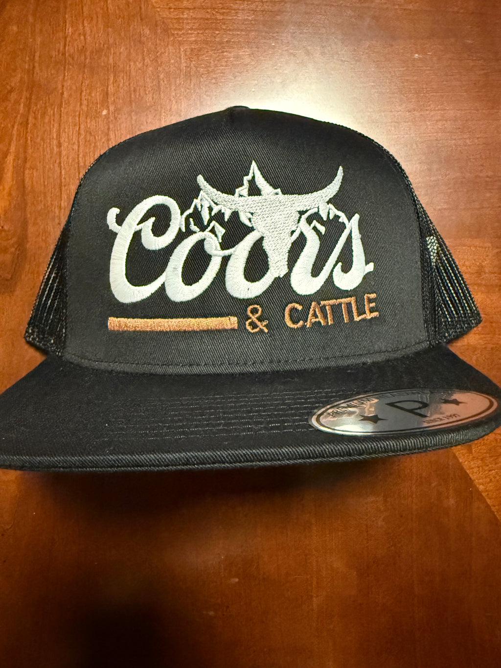 Coors and Cattle Embroidered
Flat Bill Trucker Hat “Black”